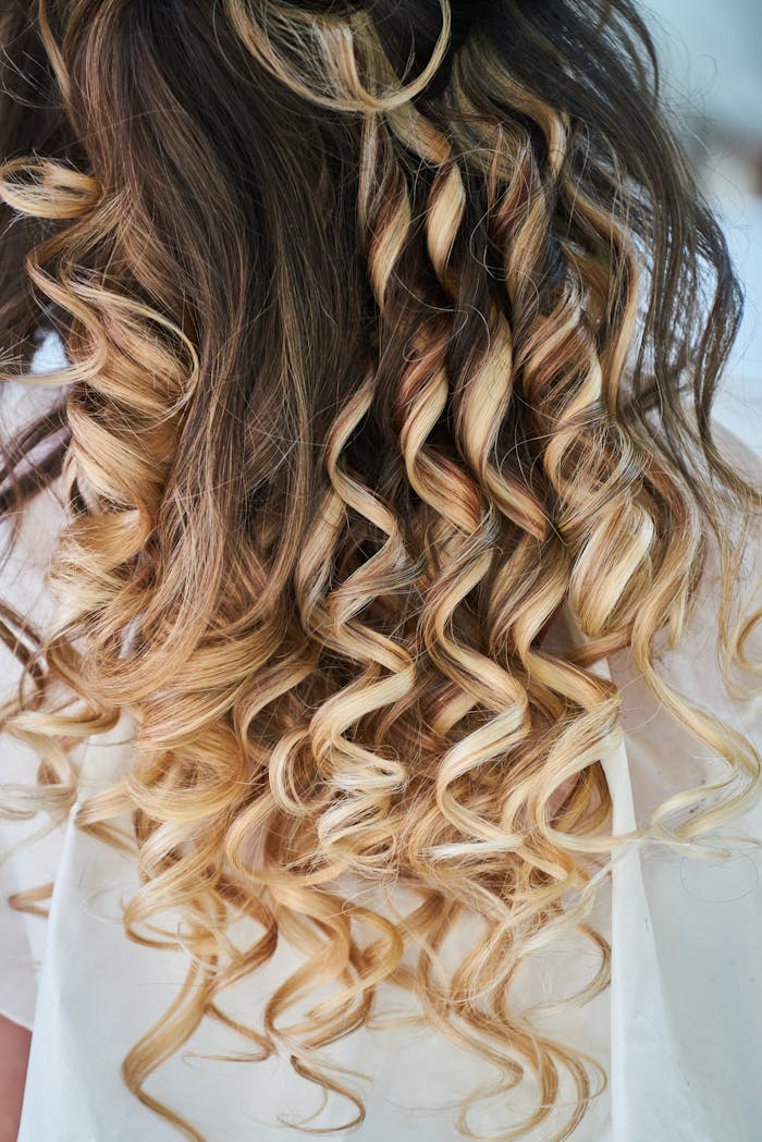 Services Close-up of elegant blonde curls showcasing detailed hairstyle design.